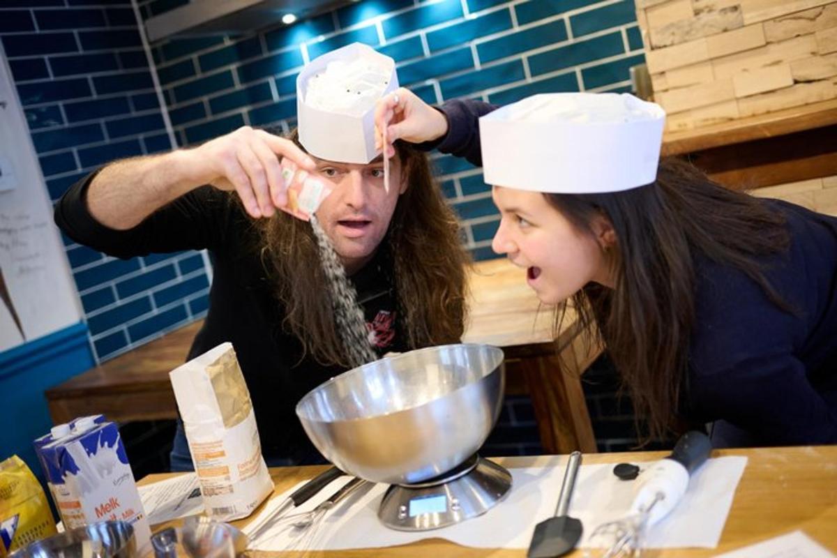 a man and a woman in a kitchen preparing food