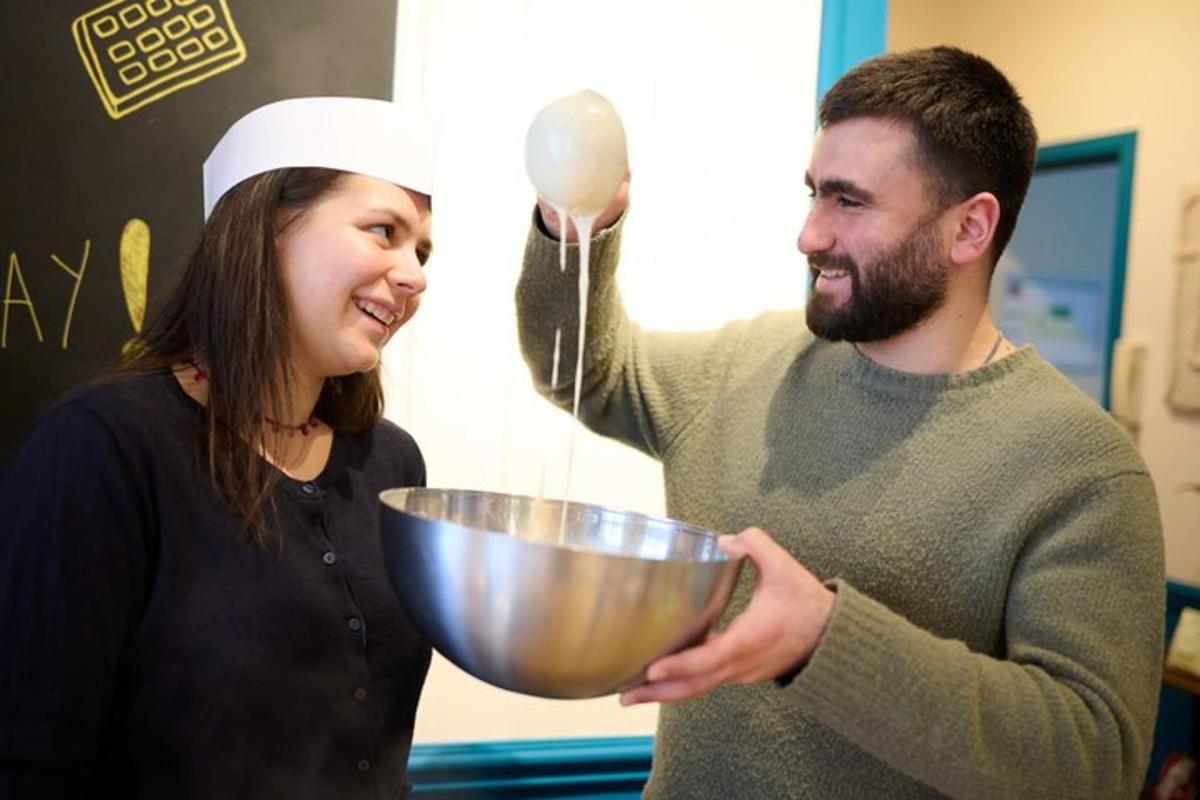 a man and a woman holding a mixing bowl