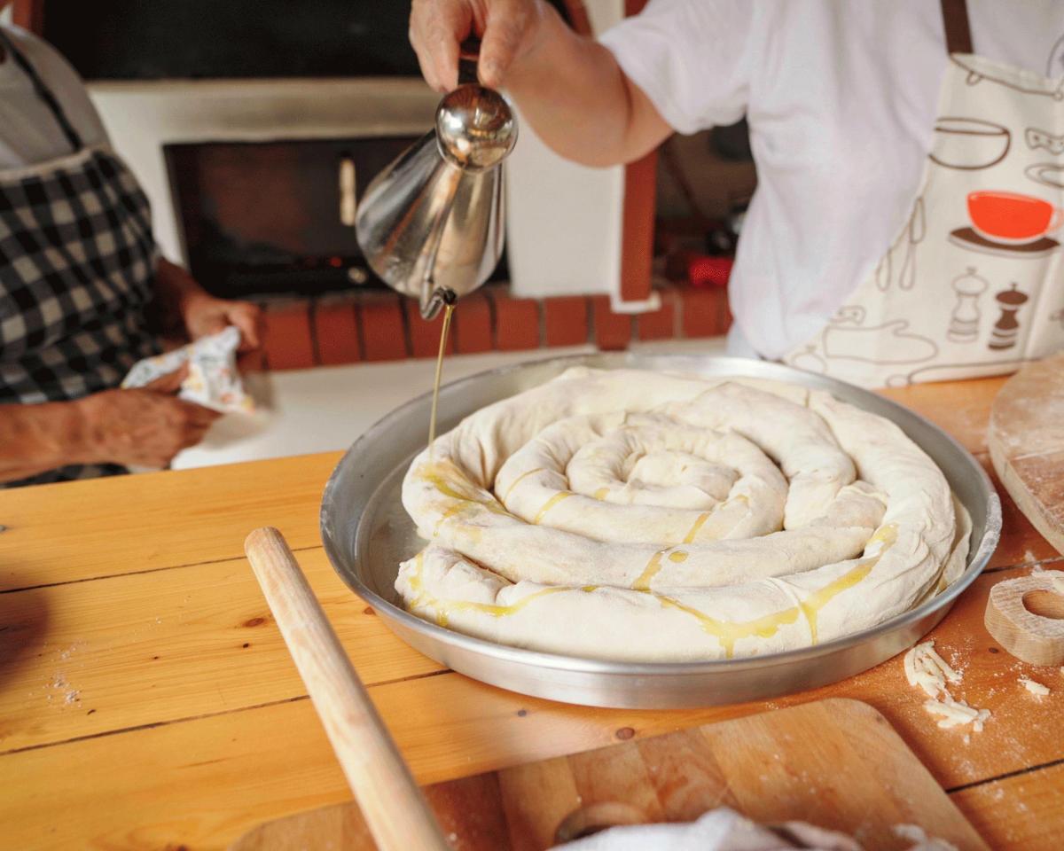 a person is preparing food in a pan on a table