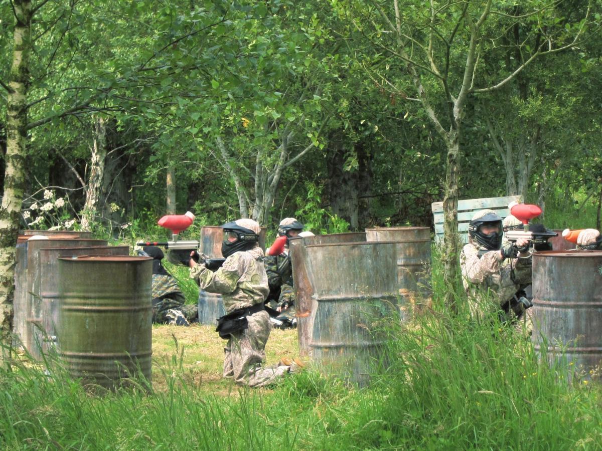 a group of soldiers jumping over a fence