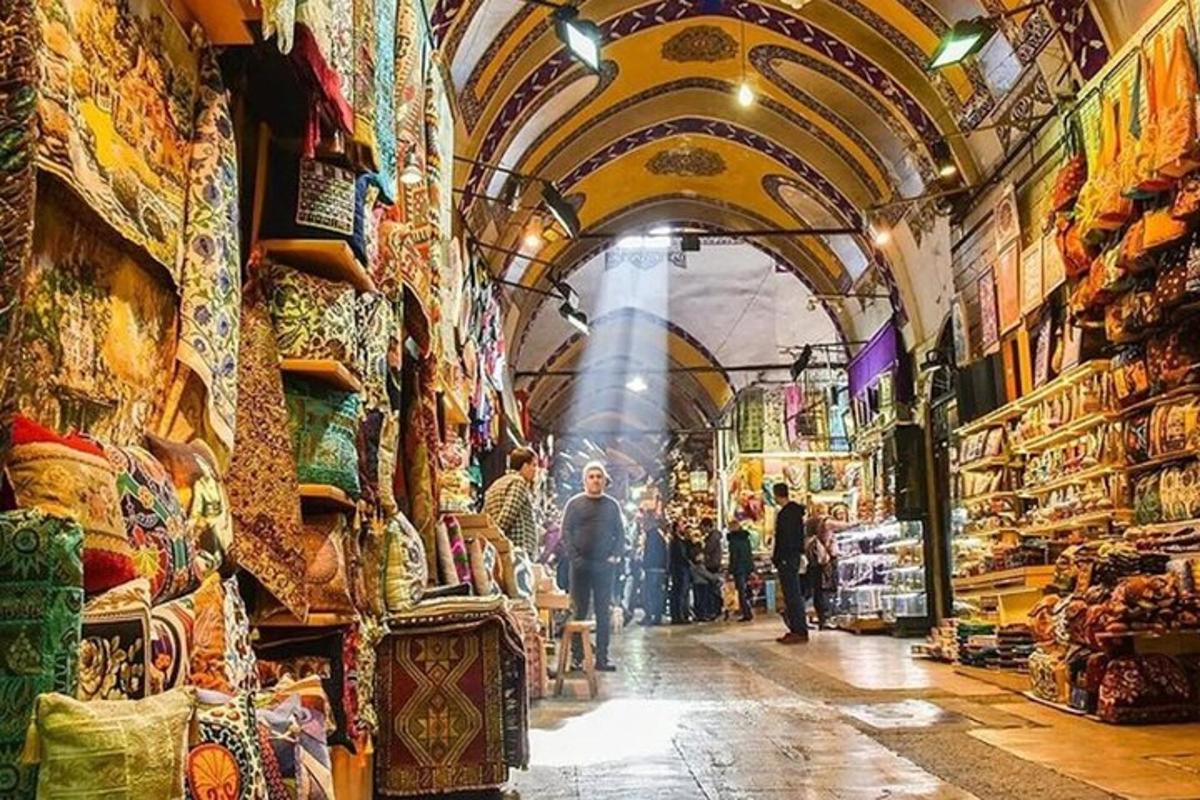 a market with people walking through the aisle of a store