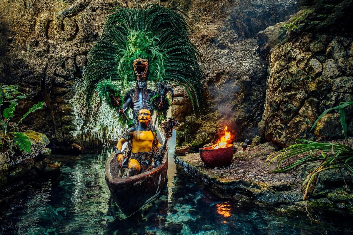 a statue of a man on a boat next to a fire