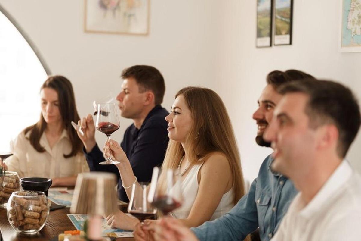 a group of people sitting at a table drinking wine