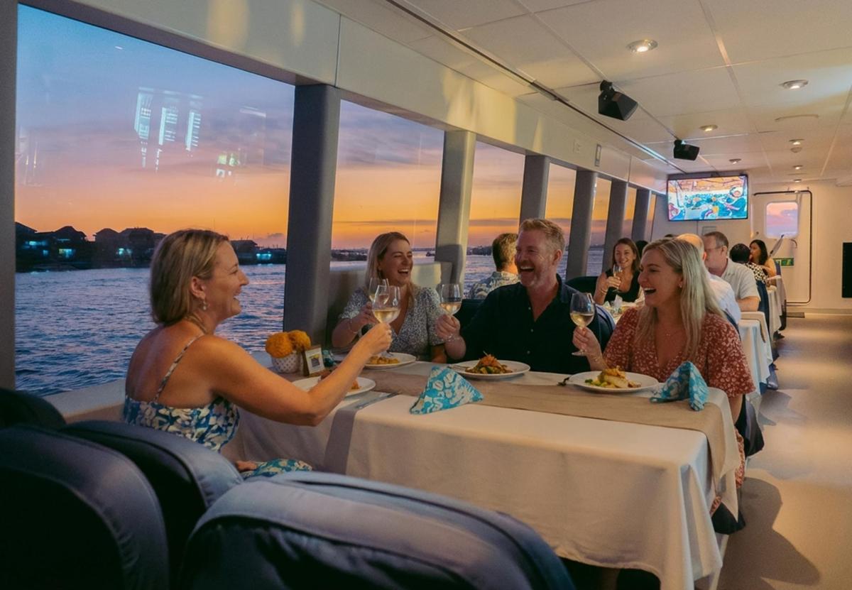 a group of people sitting at tables in a restaurant