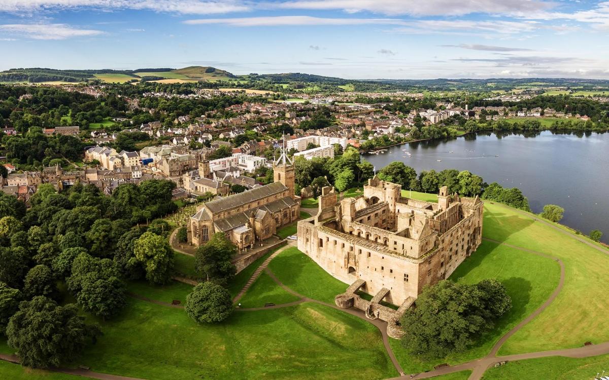 an aerial view of a castle and a lake