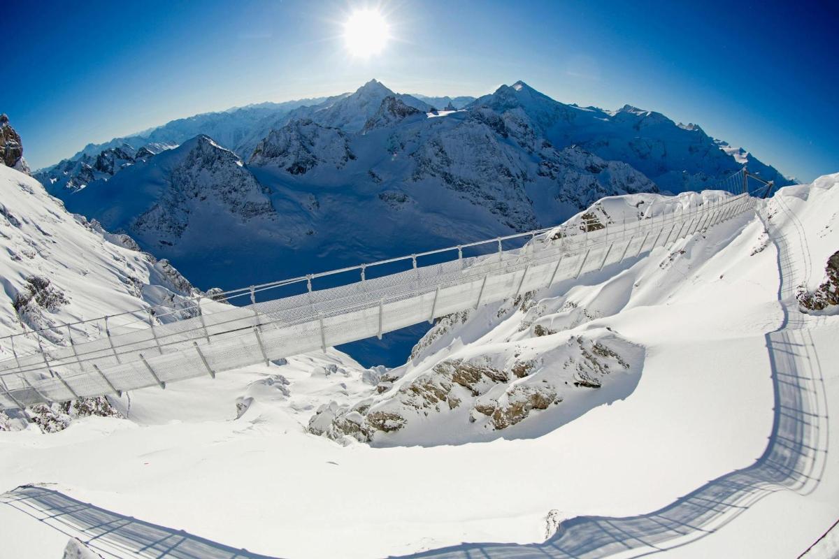 a bridge on top of a snow covered mountain