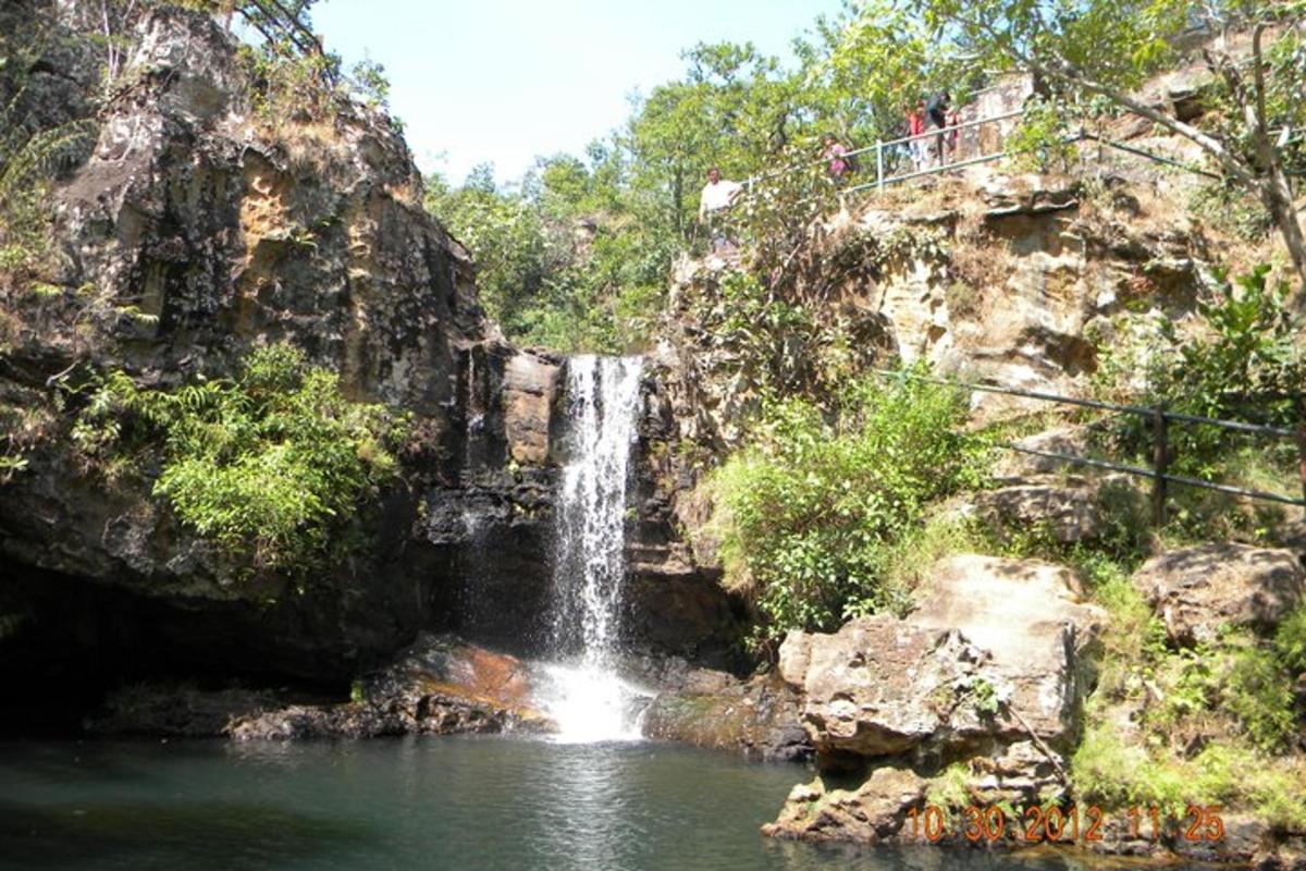 a waterfall in the middle of a pool of water