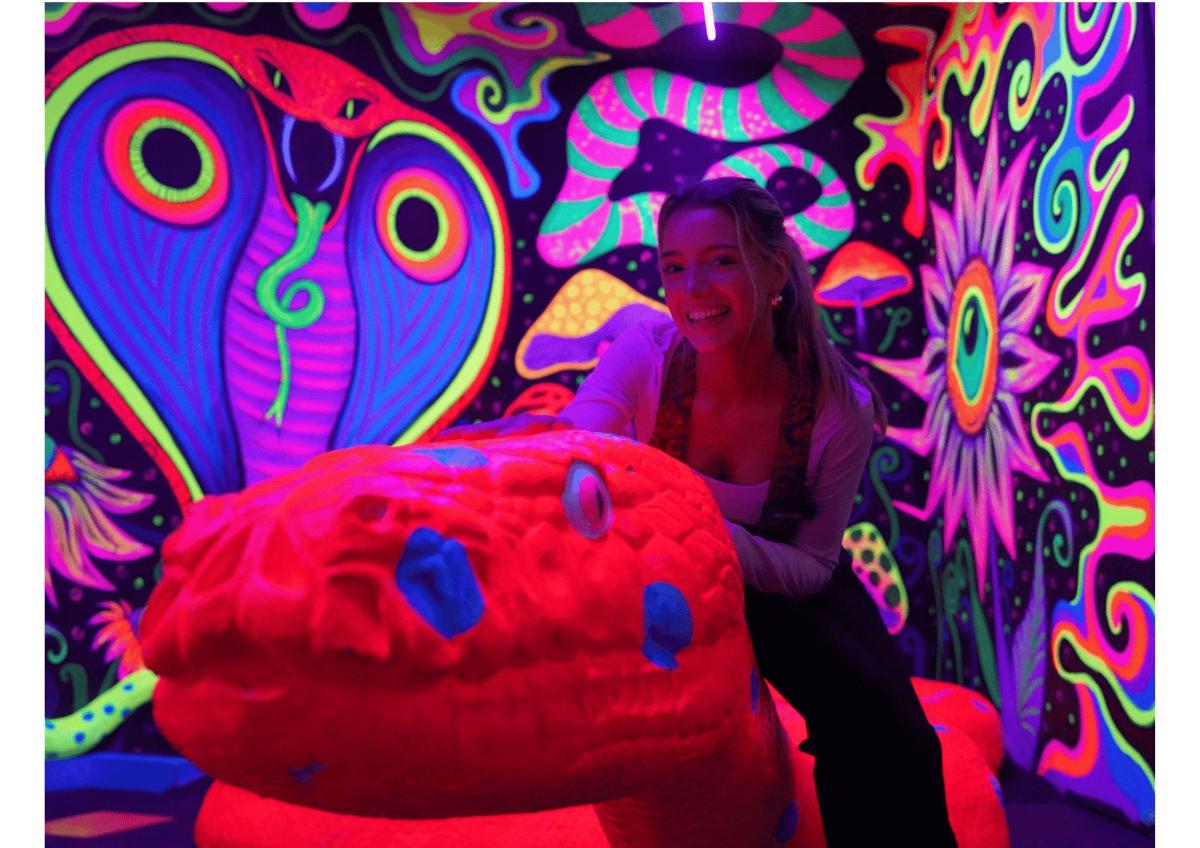 a woman sitting on a bean bag chair in front of a painting