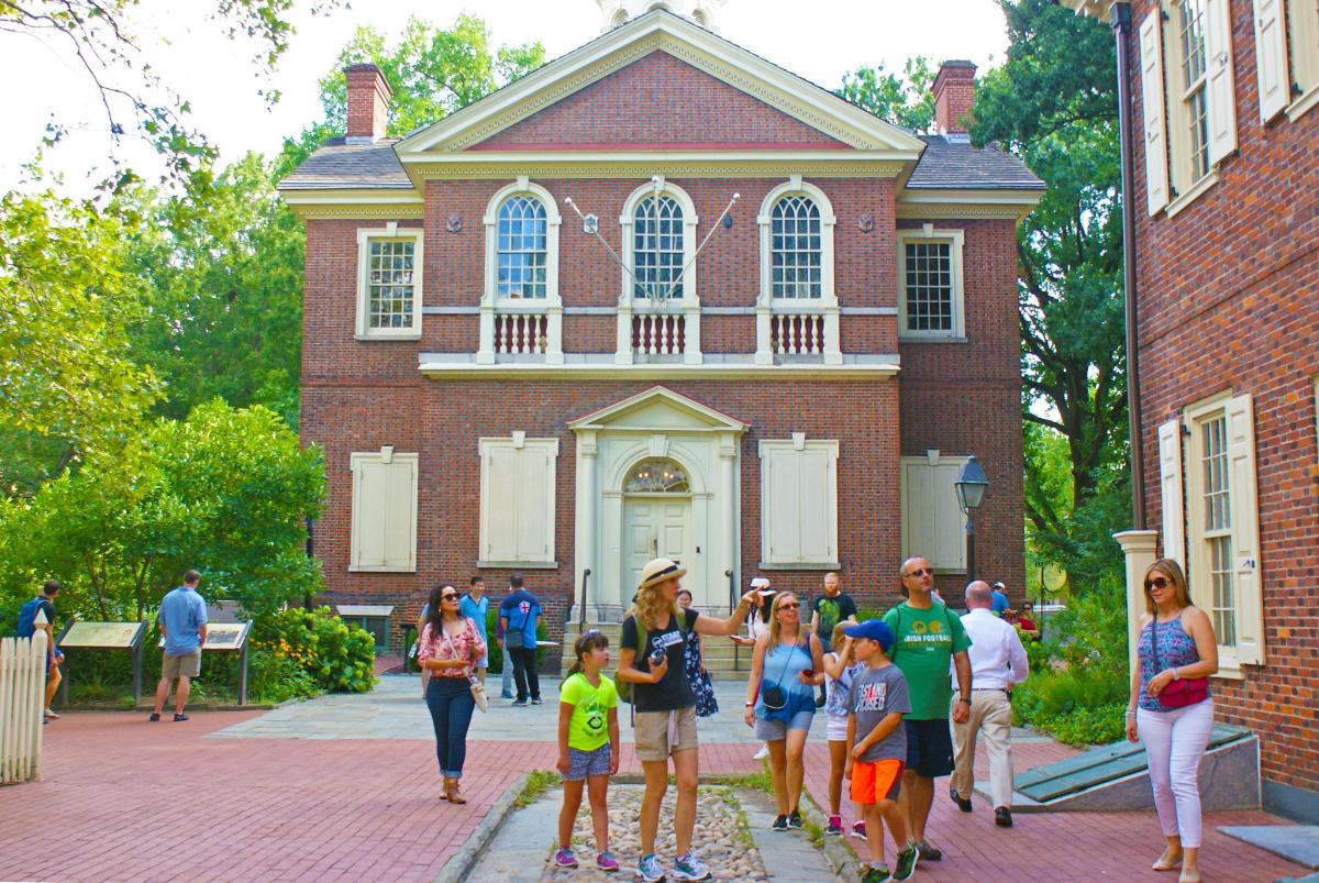 a group of people walking in front of a building