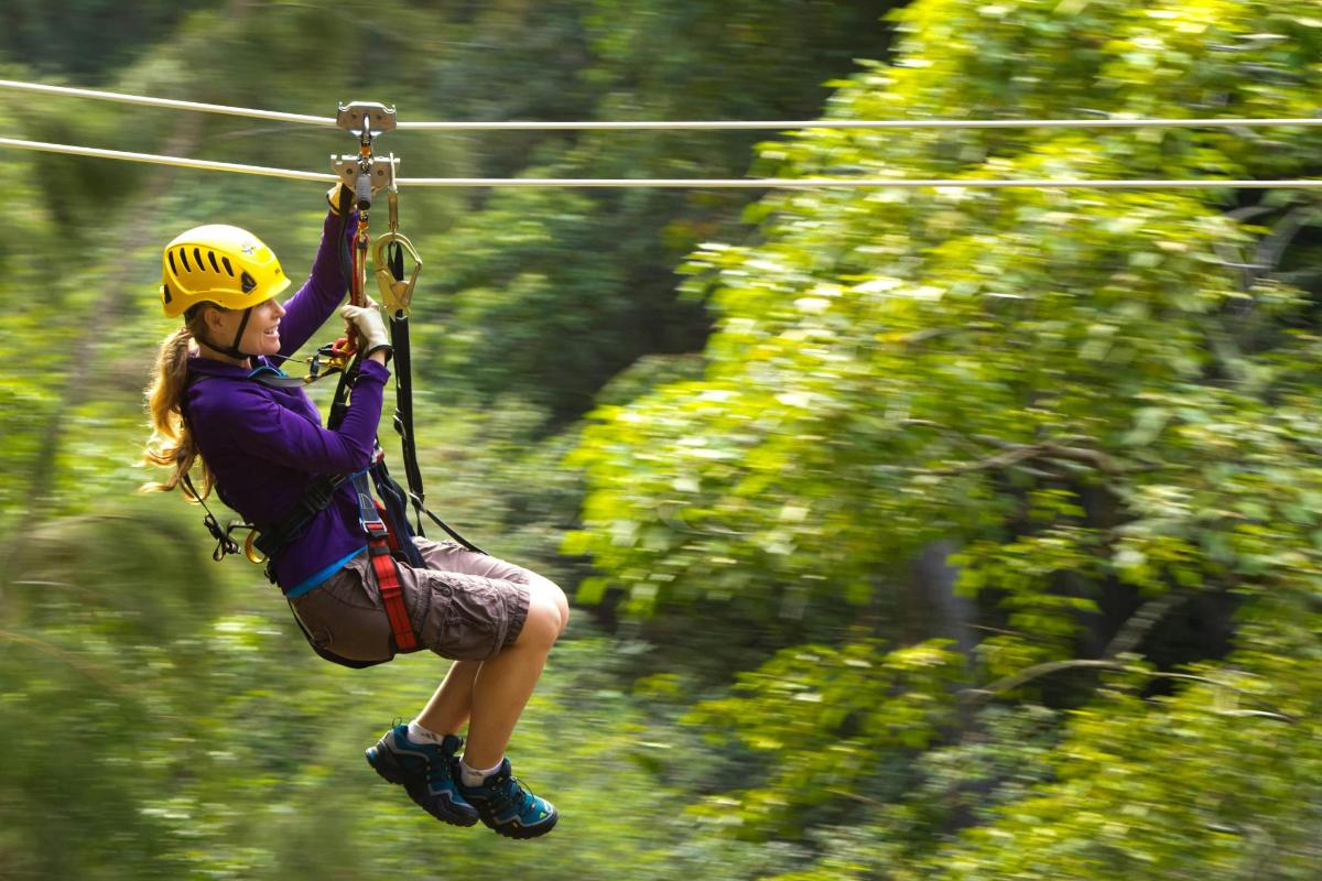 a woman riding on a zip line