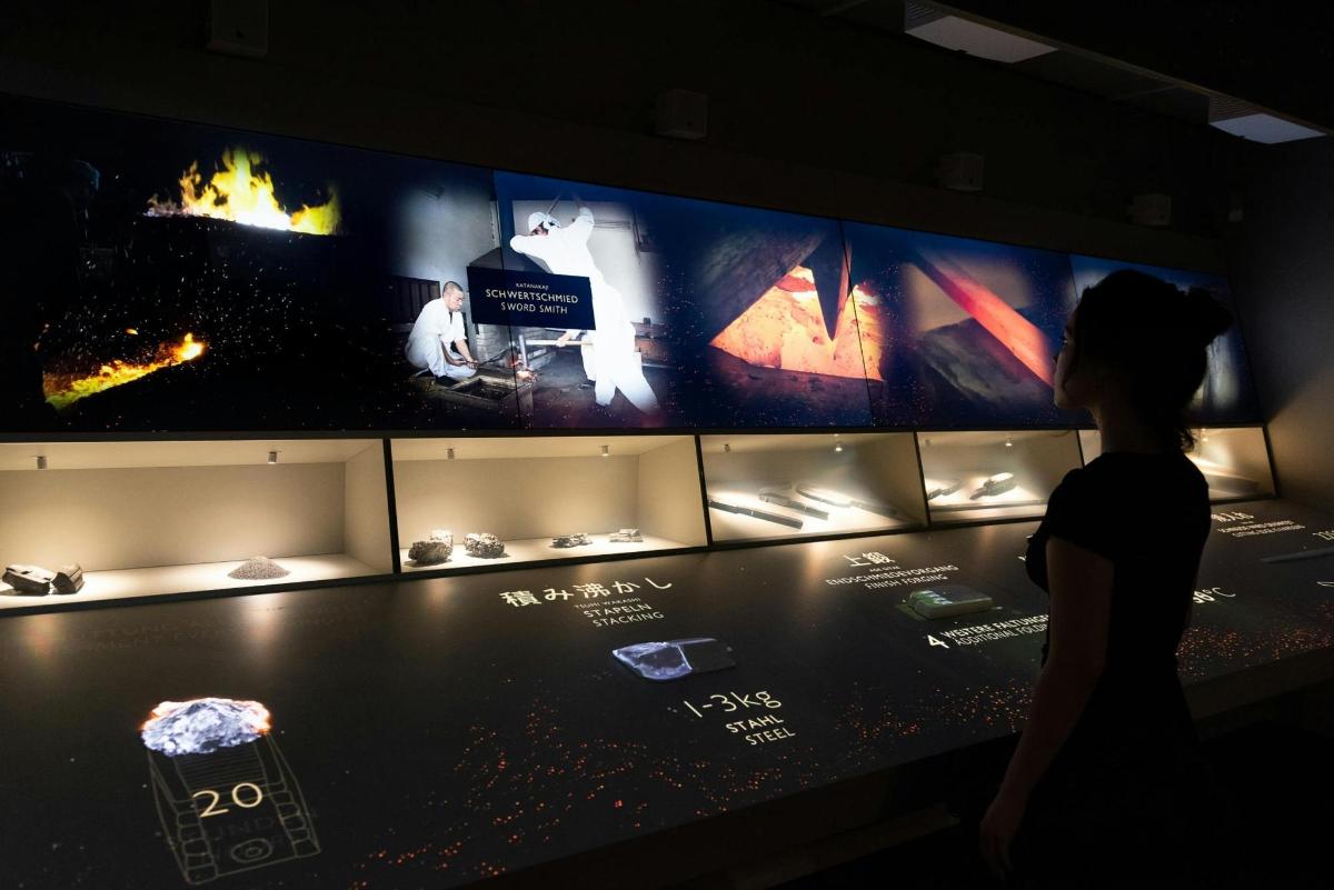 a woman looking at a display in a museum