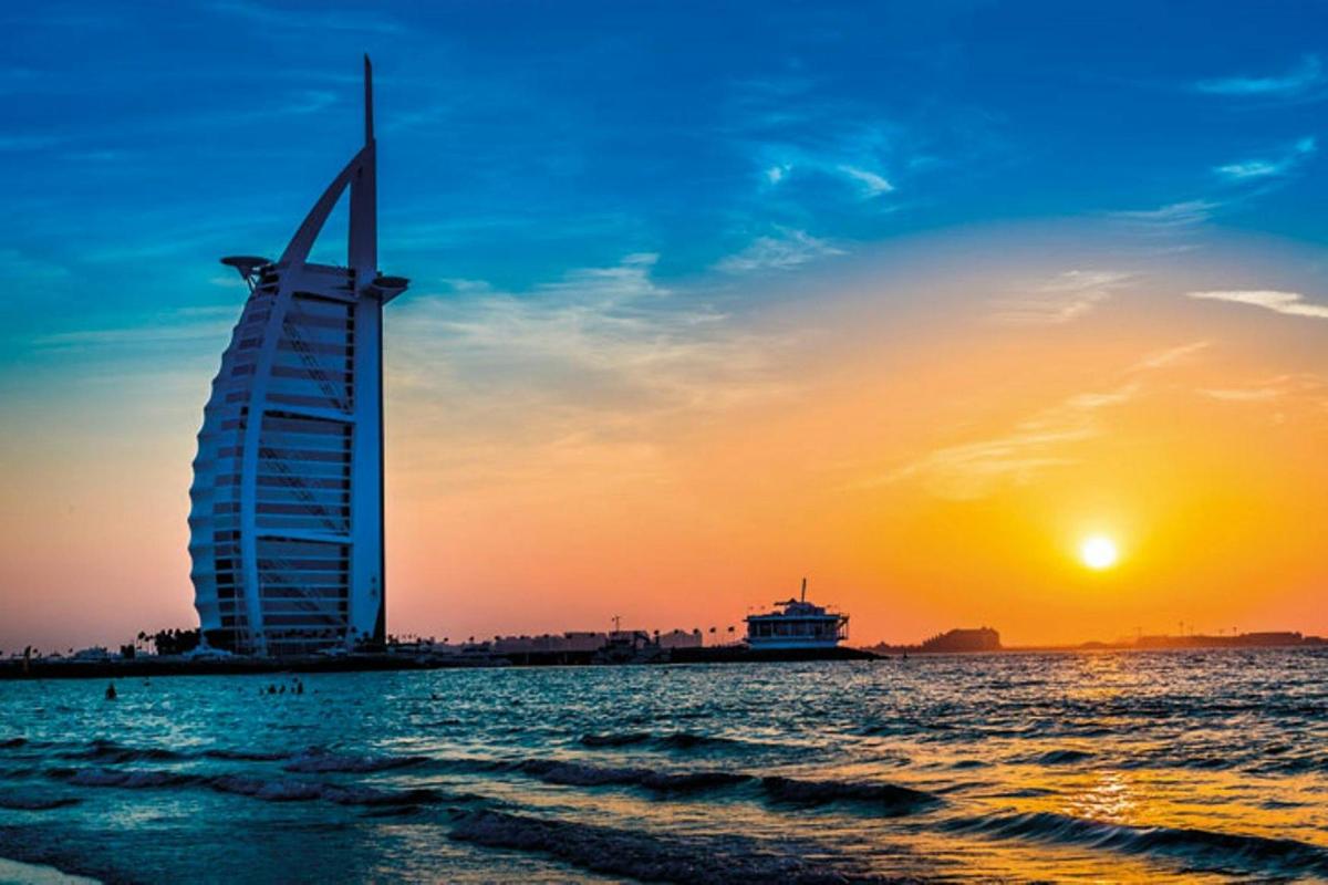 a view of the burj al arab at sunset