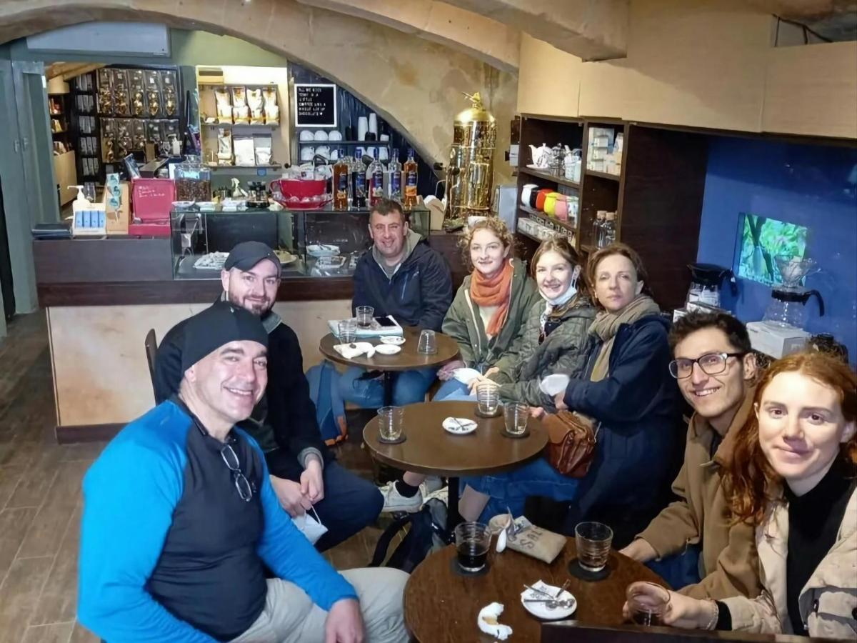 a group of people sitting at tables in a restaurant