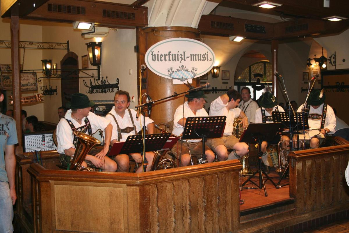 a group of musicians sitting in a room with instruments