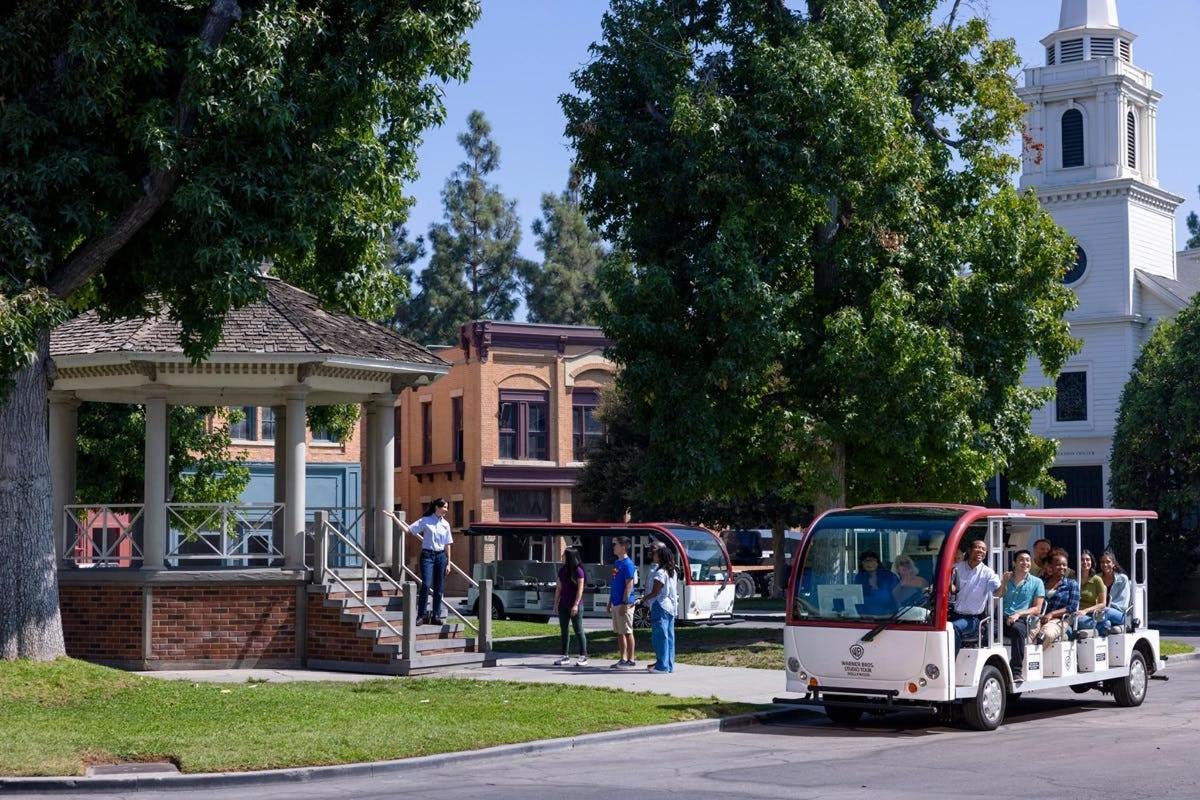 a small bus with people in it driving down the street