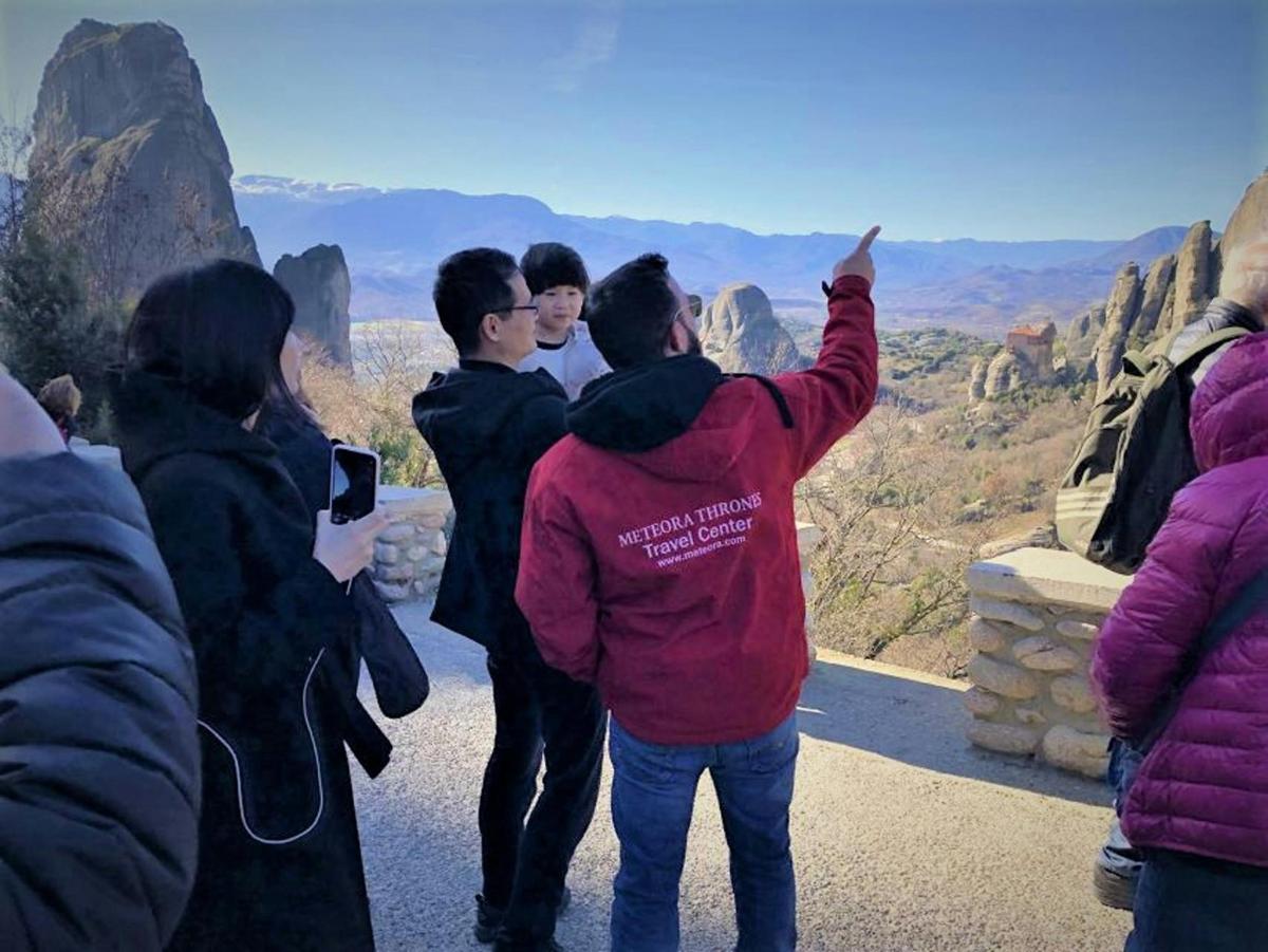 a group of people looking at the view at the grand canyon