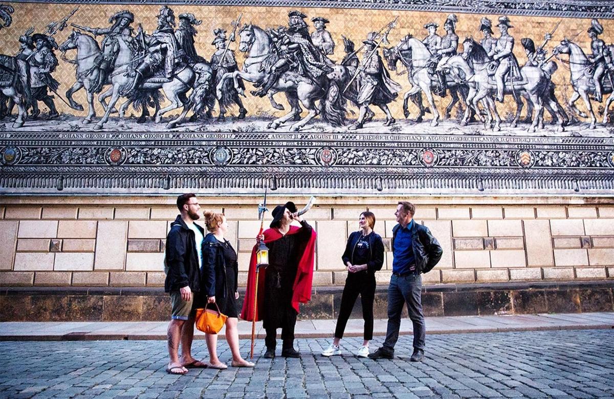 a group of people standing in front of a statue
