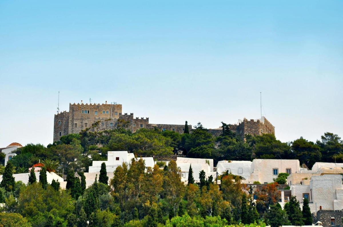 a castle on top of a hill with trees