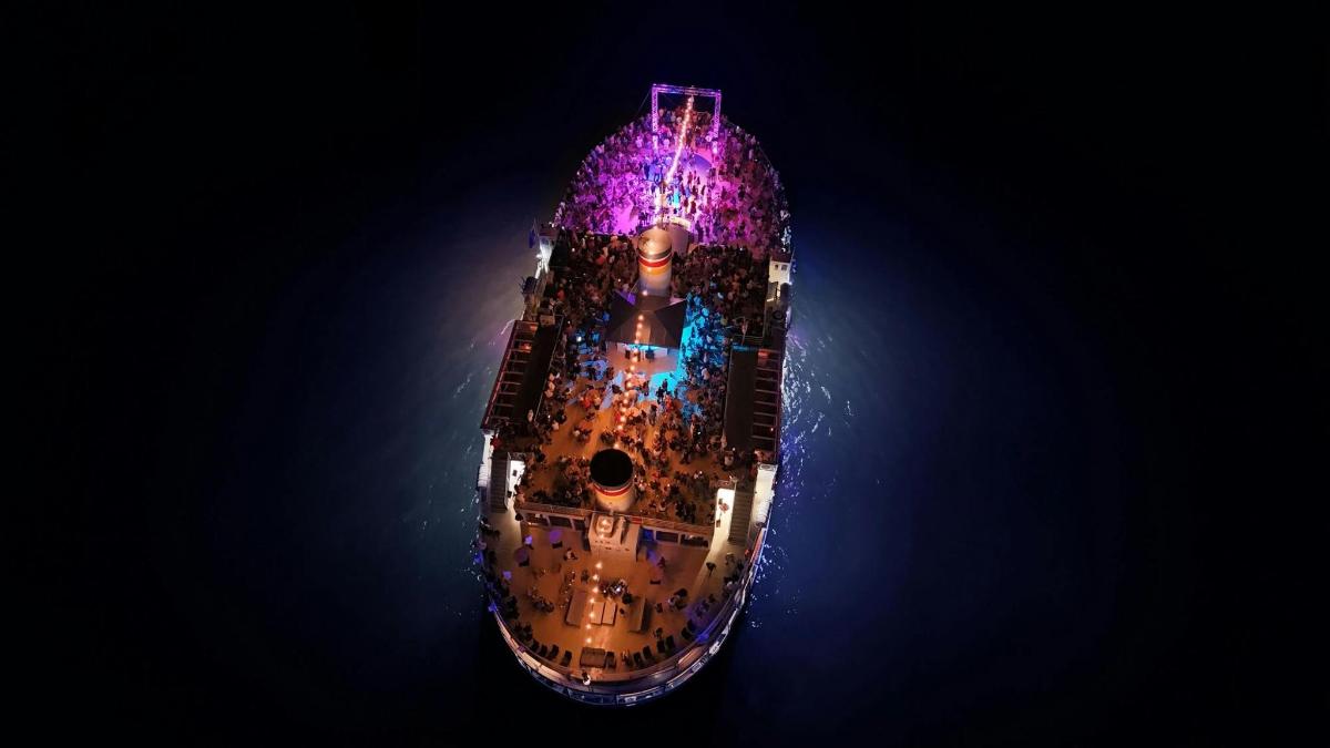 an overhead view of a building with lights on it