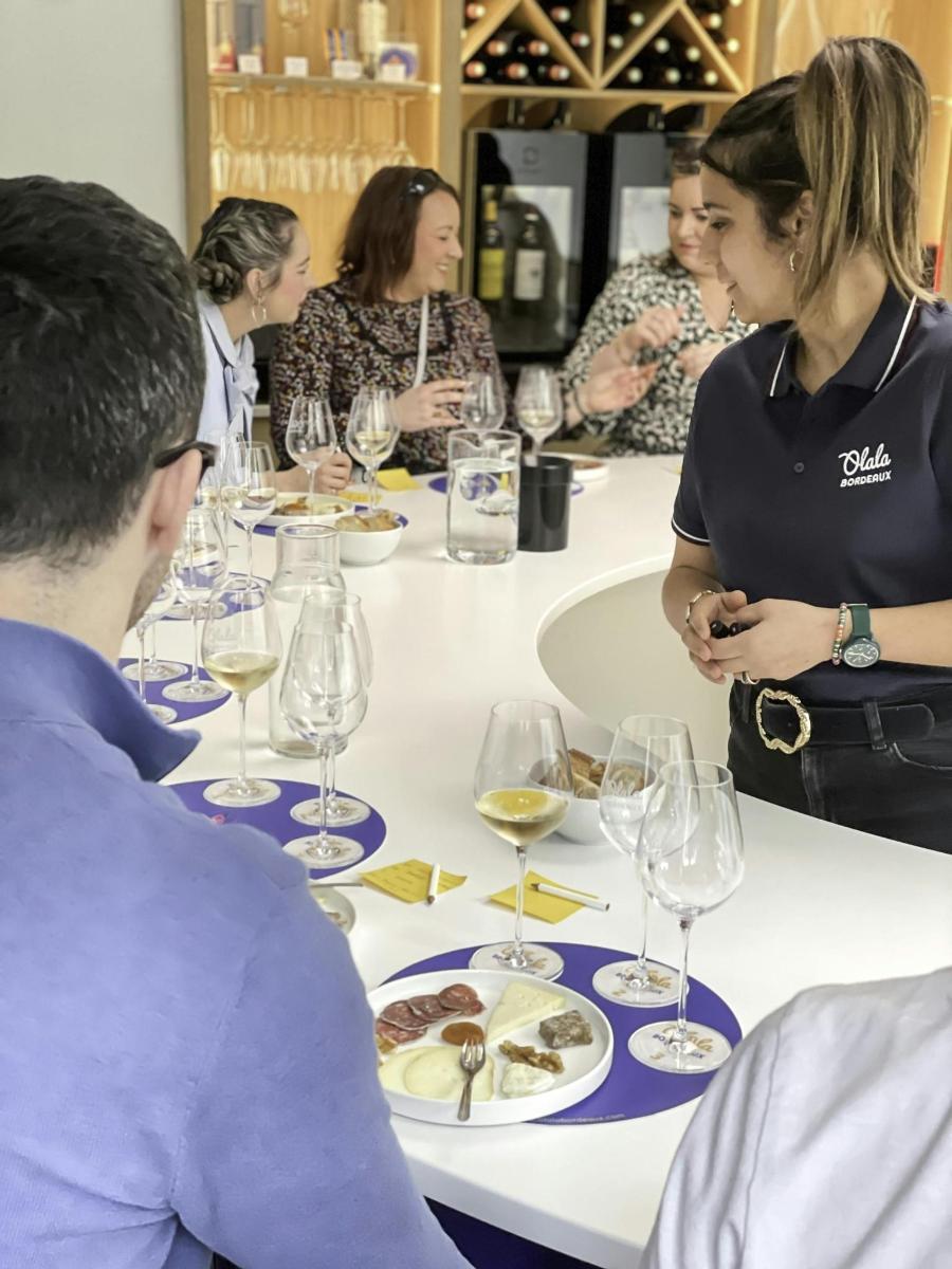 a group of people sitting around a table with wine glasses