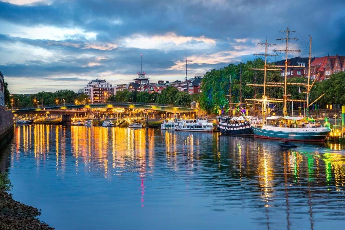 a group of boats docked in a marina at night