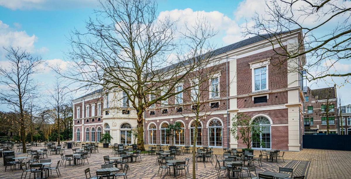 a building with tables and chairs in front of it