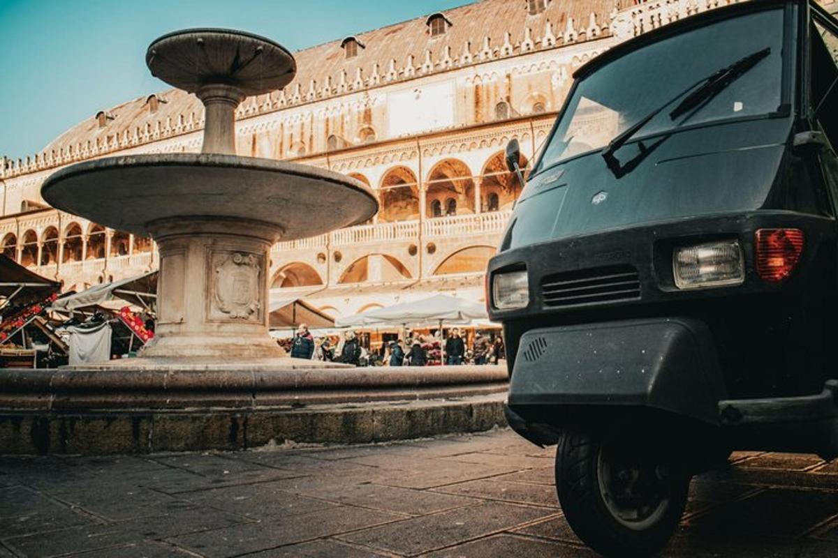 a van parked next to a fountain in front of a building