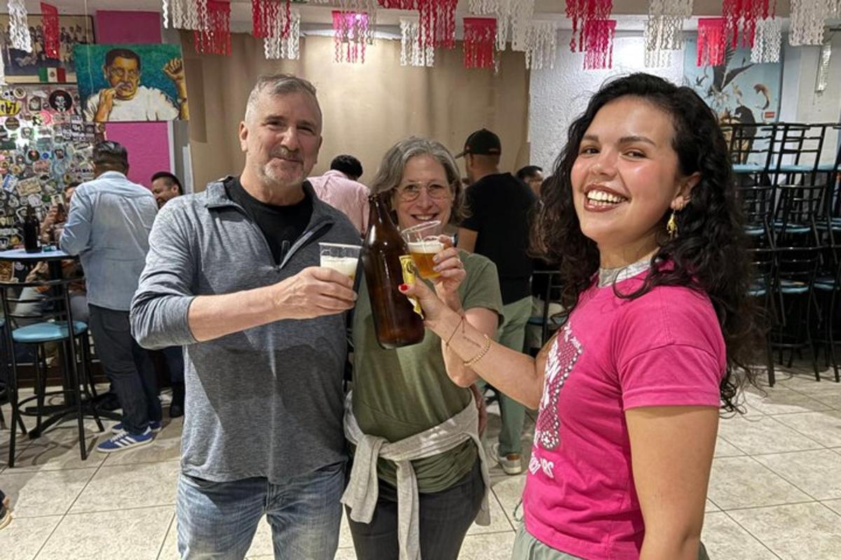 a group of people holding up glasses of beer