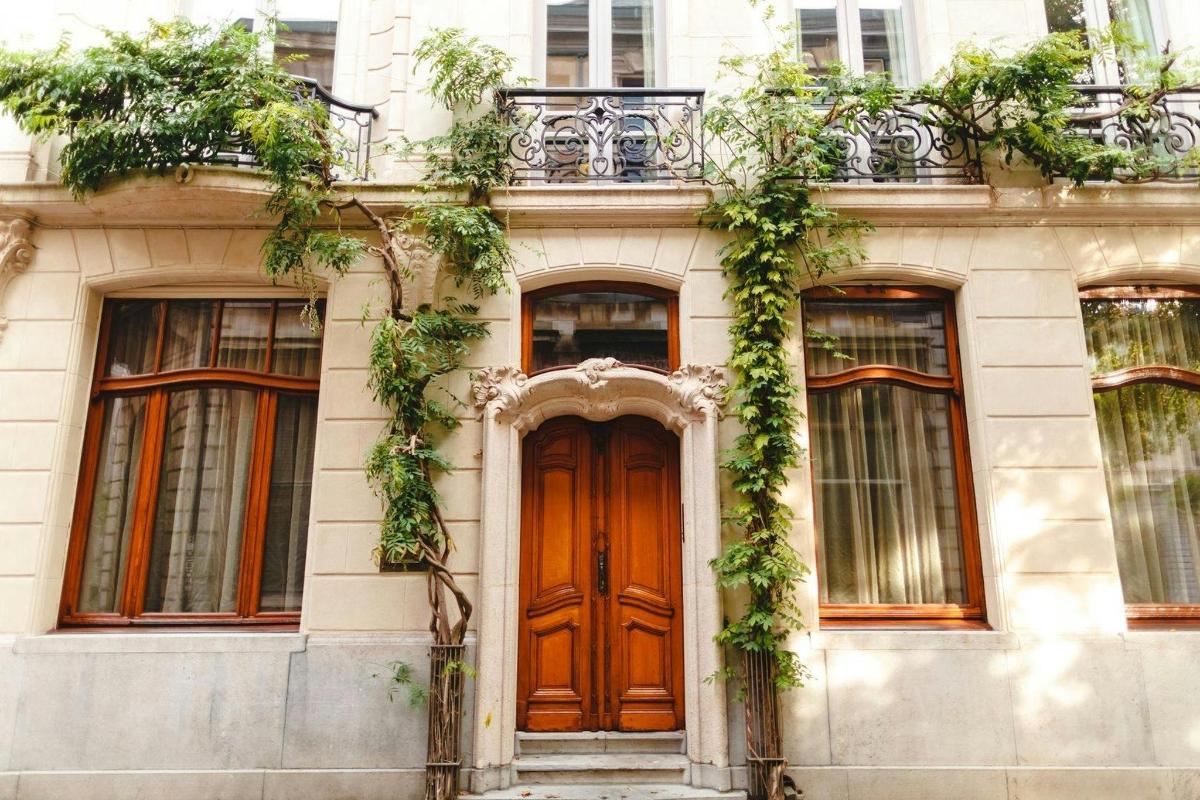 a building with a wooden door and ivy