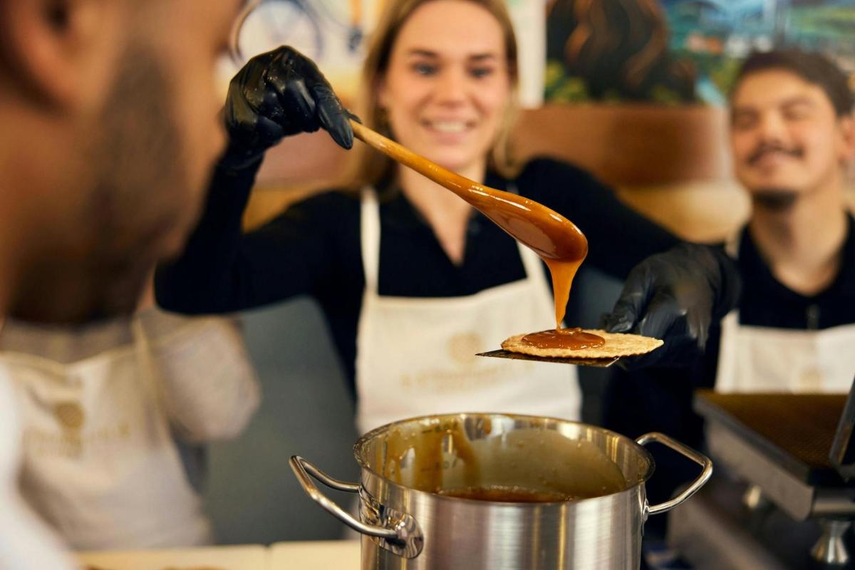 a woman in a kitchen preparing food with a spatula