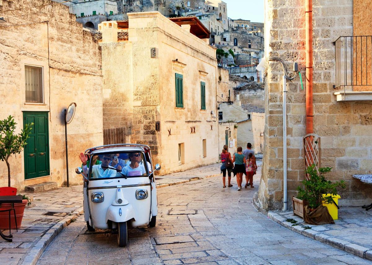 a small car with a face on it parked on a street