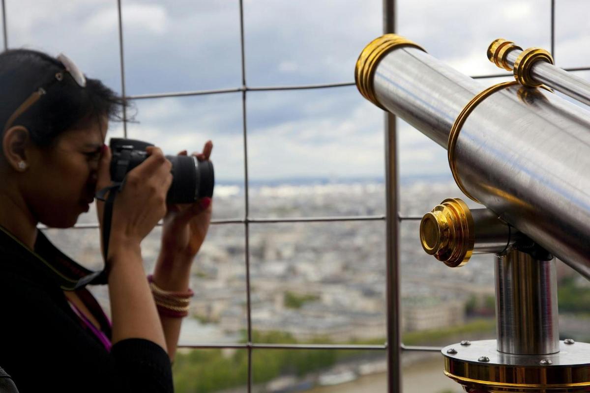 a woman taking a picture of a city with a camera