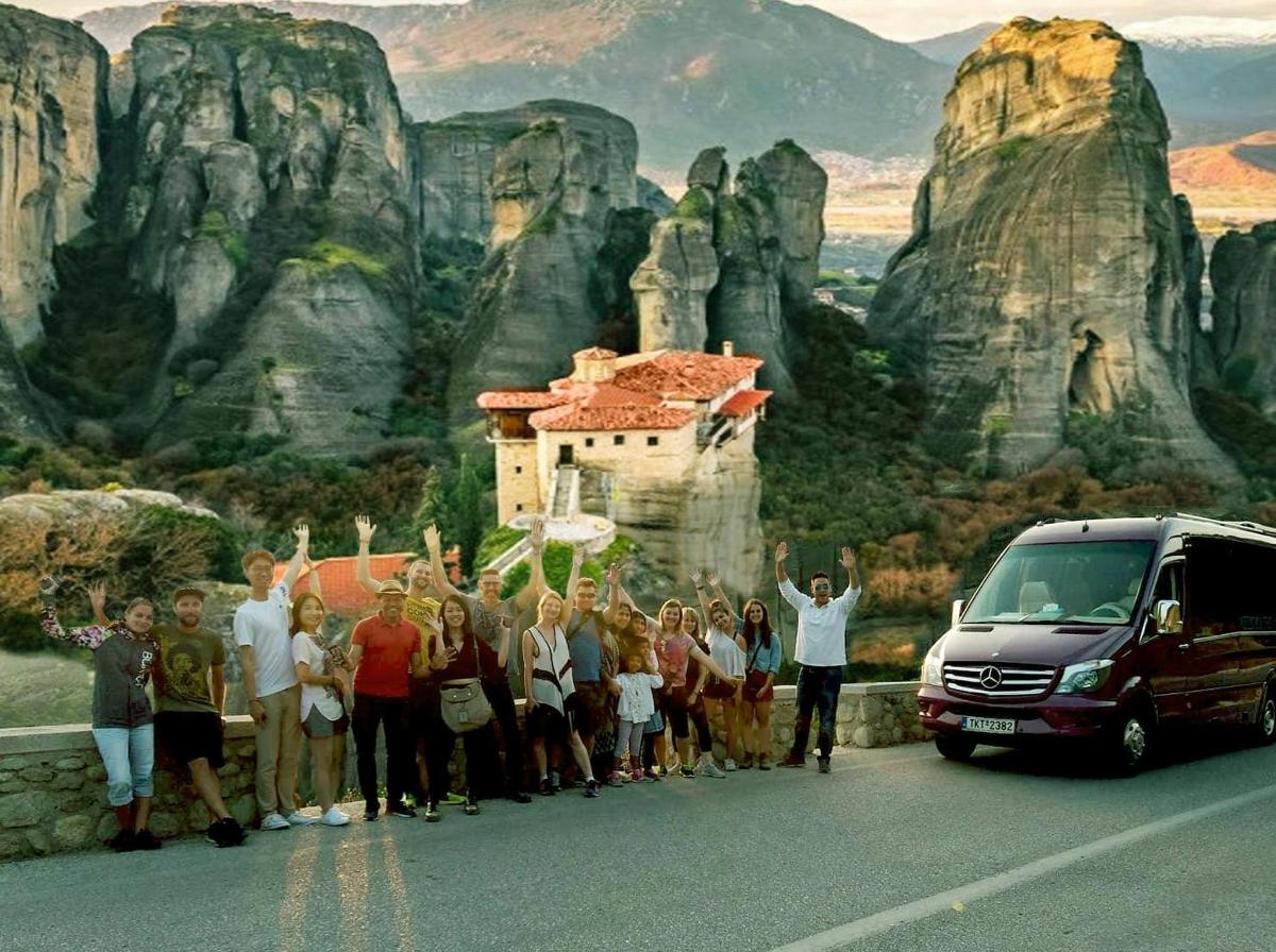 a group of people standing on a road next to a van