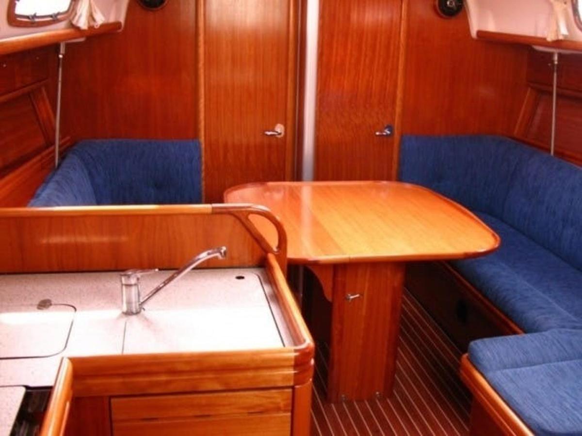 a small boat with a table and blue seats