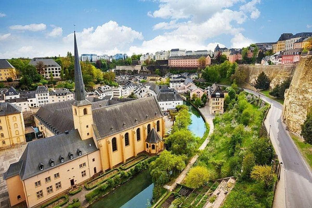 an aerial view of a city with a church and a river