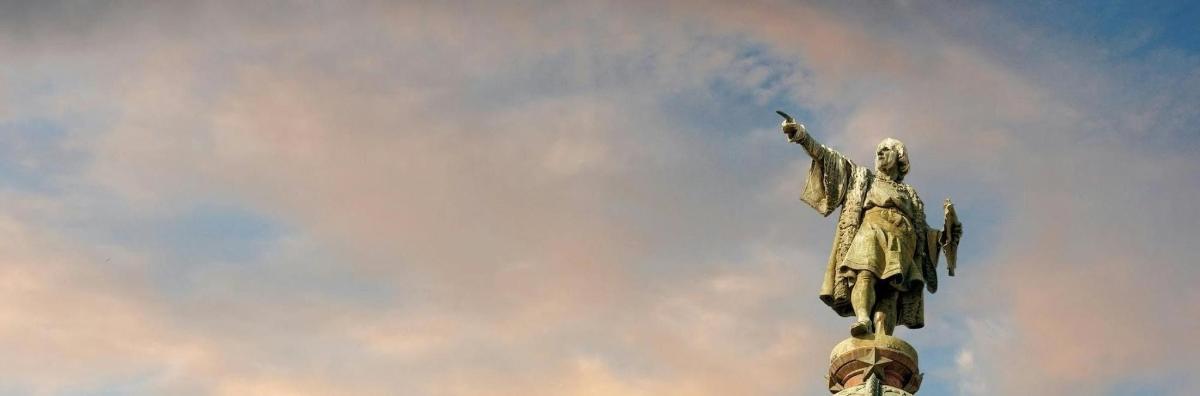 a statue on top of a building with a cloudy sky