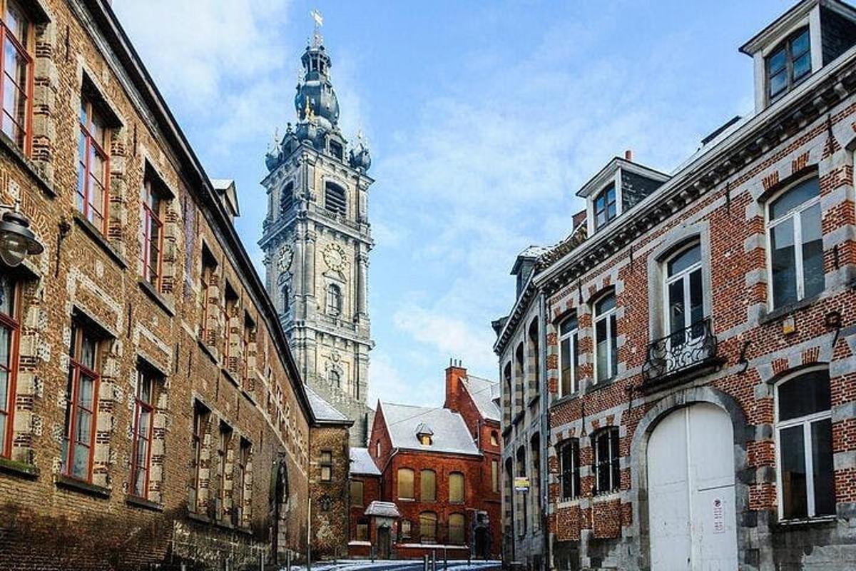 a clock tower in the middle of a city with buildings