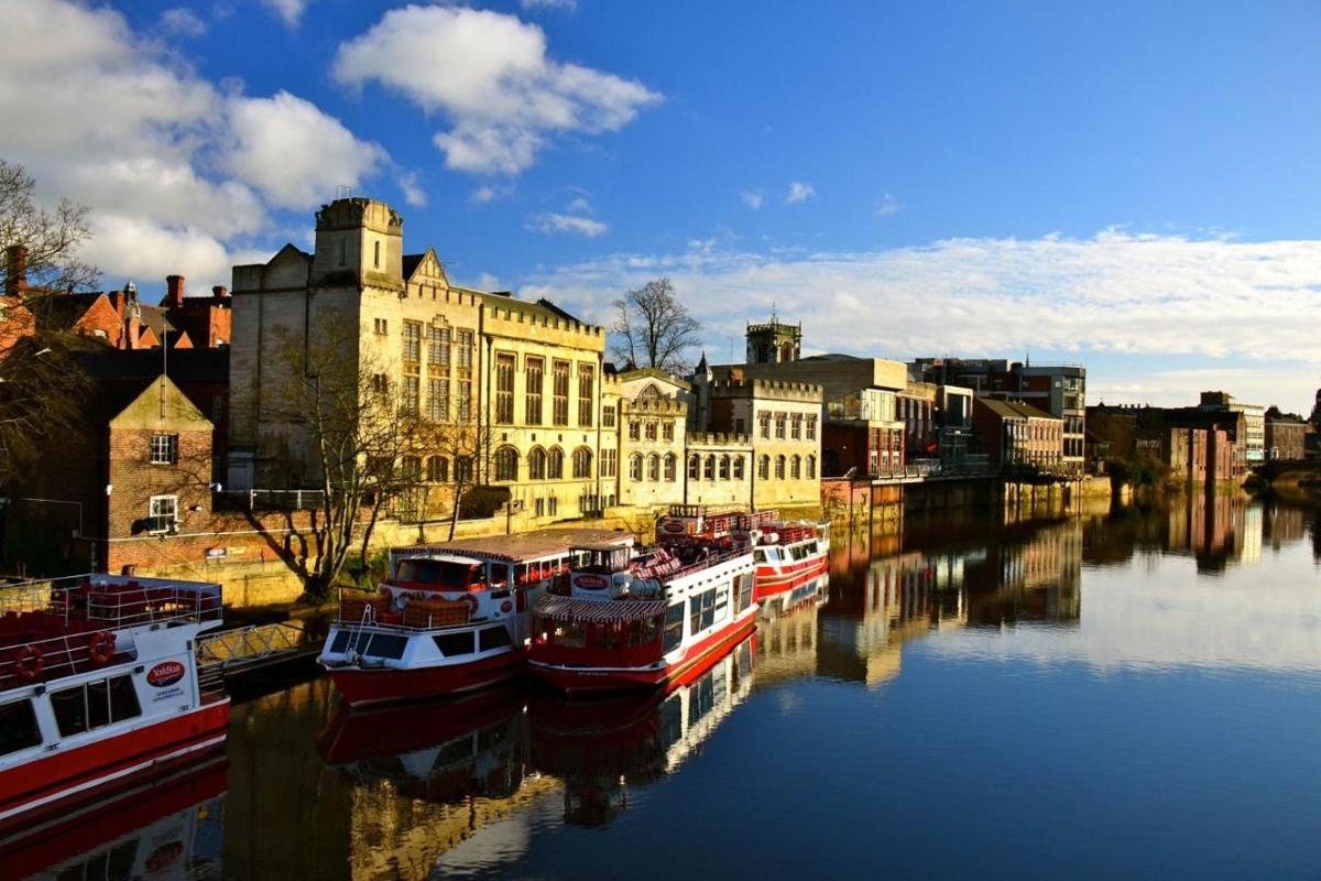 a group of boats docked in a river with buildings