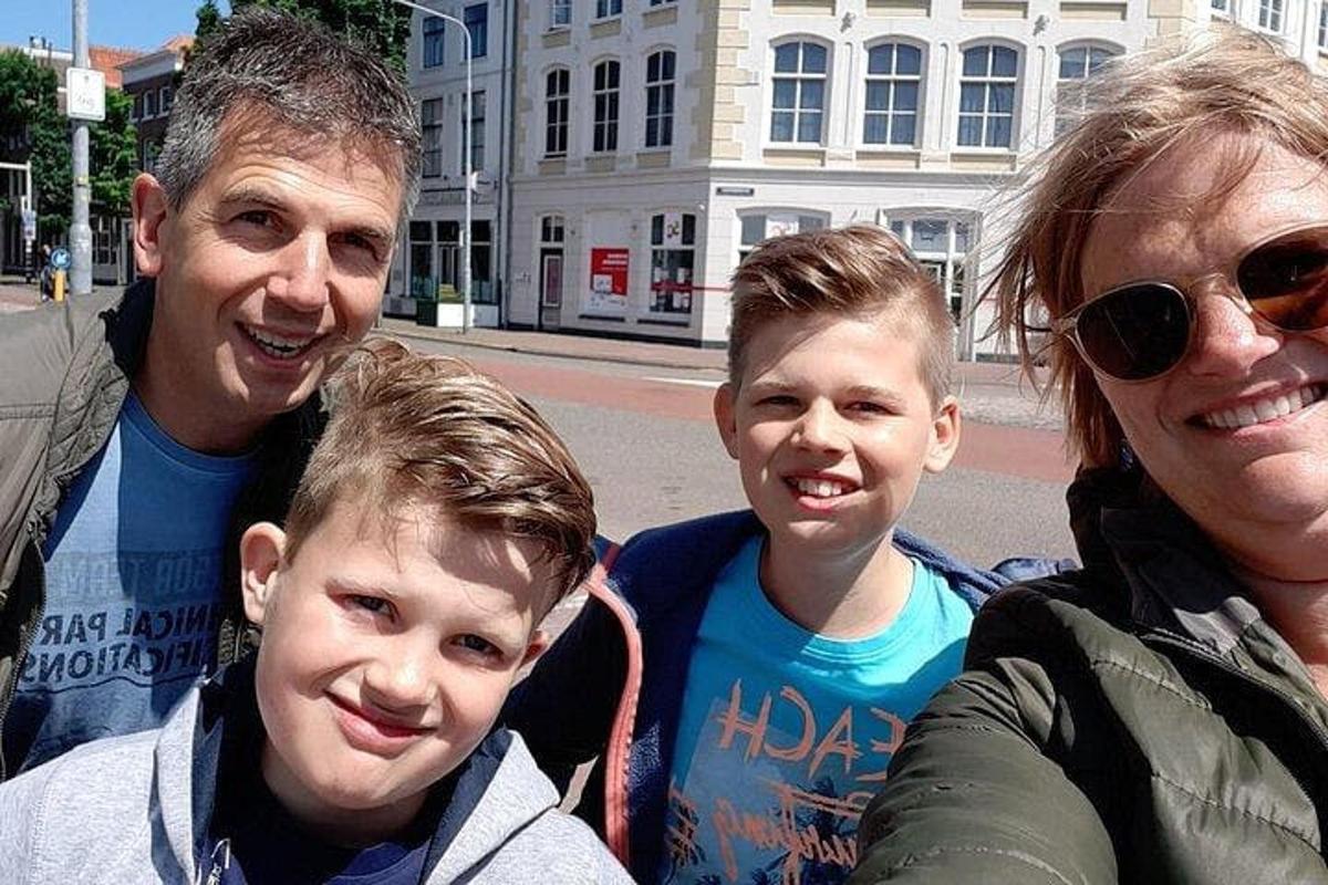 a family posing for a picture on the street