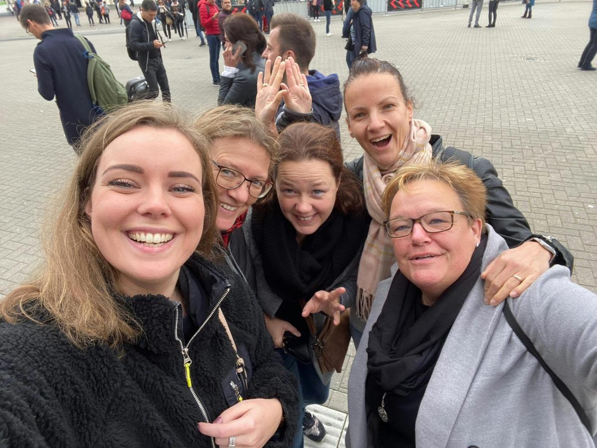 a group of people are posing for a picture