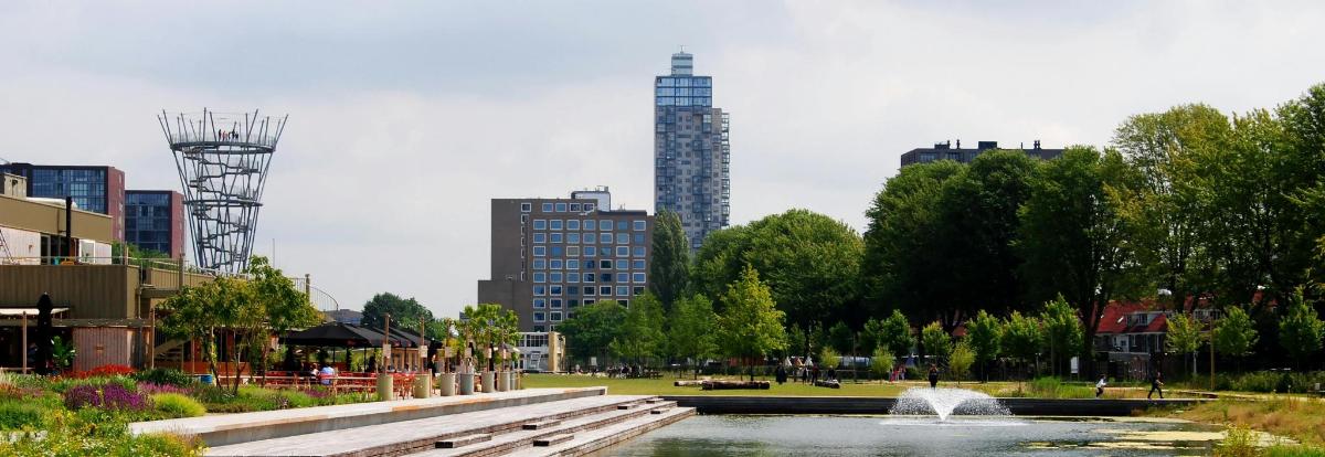 a fountain in a park in a city with buildings