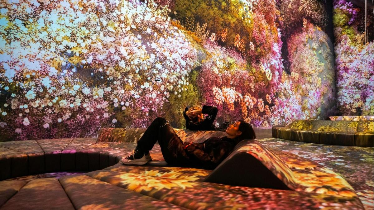 a person laying on a bed in front of a wall