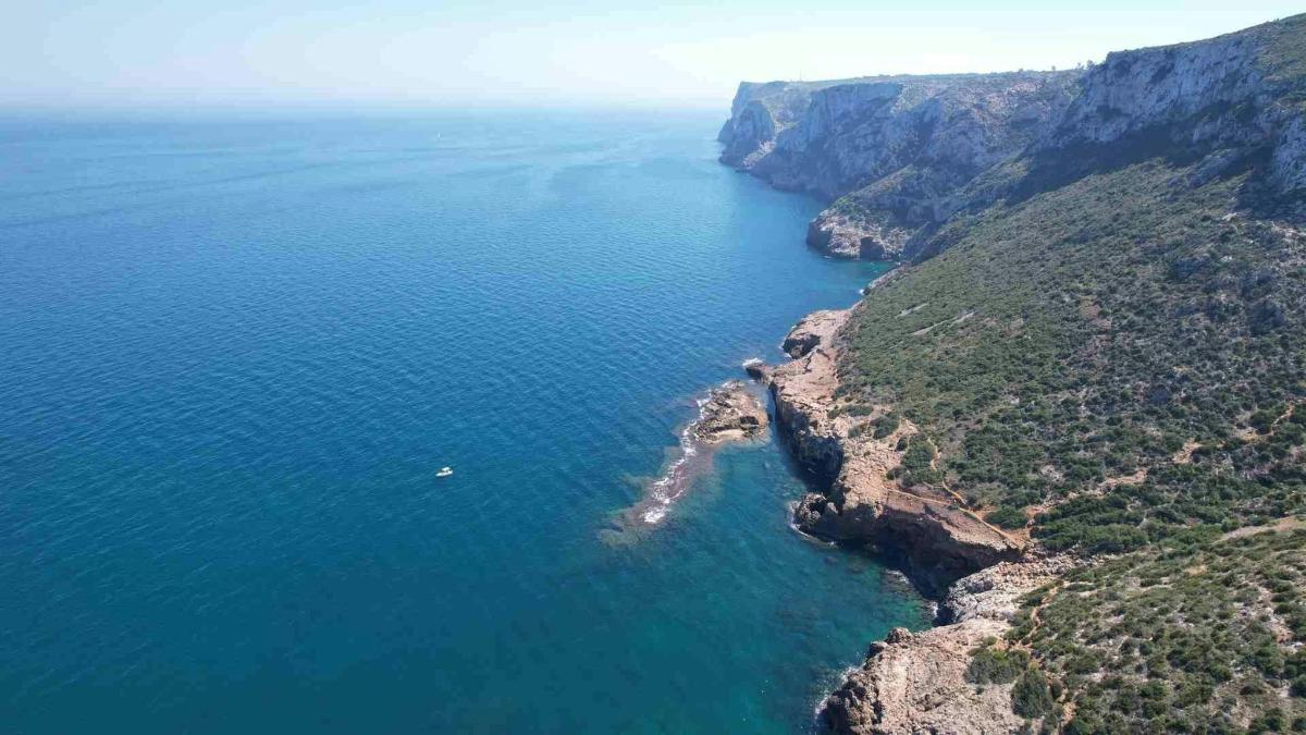 an aerial view of the ocean near a cliff