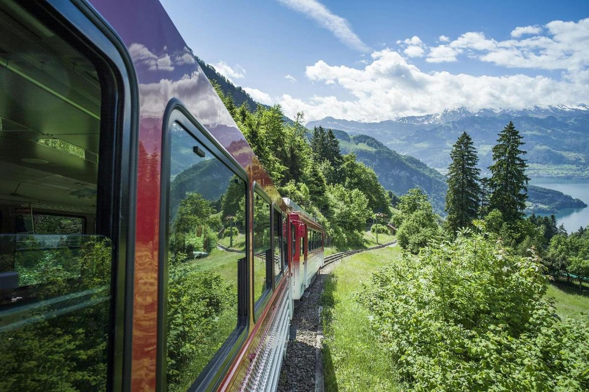 a train is looking out the window at a mountain view
