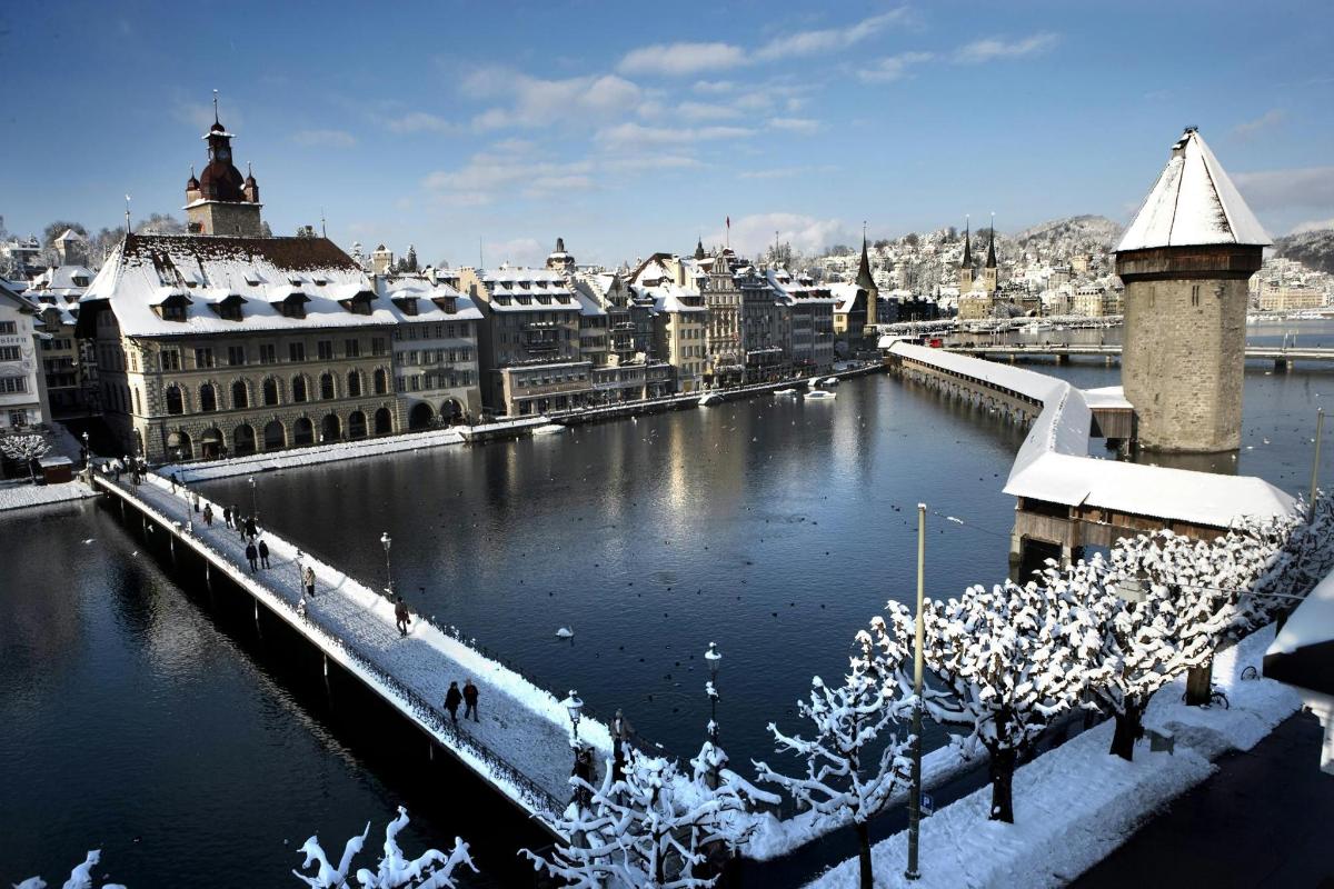 a view of a city with snow covered buildings and a river