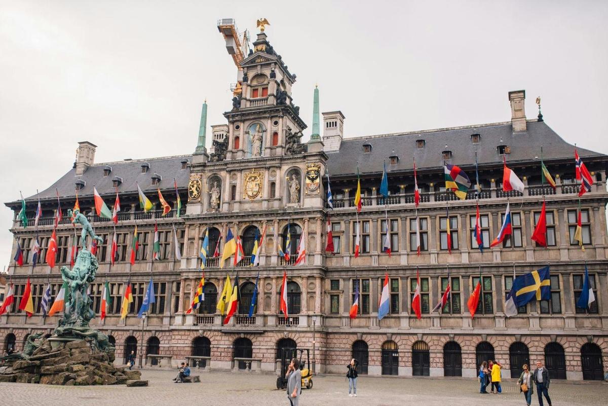 a large building with a bunch of flags on it