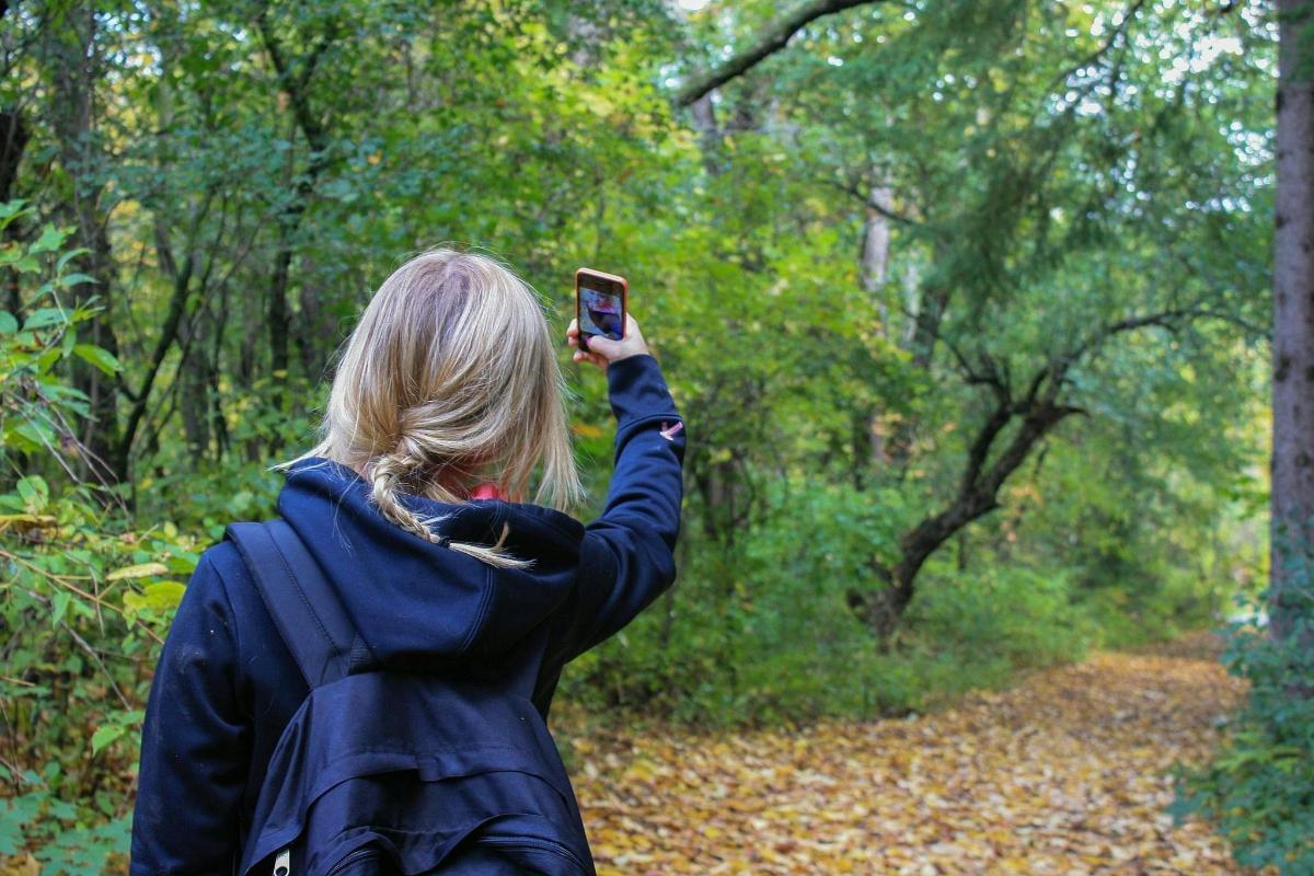a woman taking a picture with her cell phone
