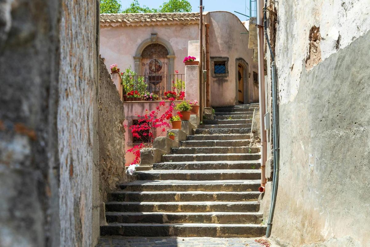 an alley with stairs leading up to a building