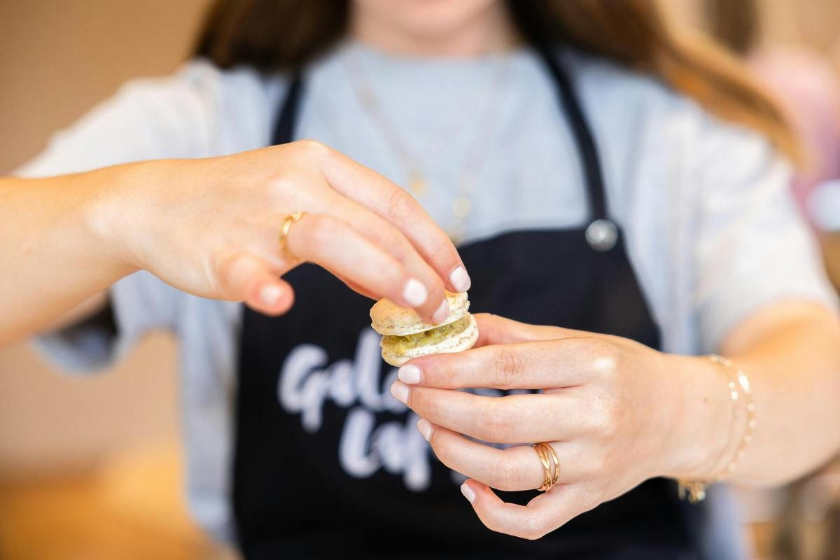 a woman holding a piece of food in her hands