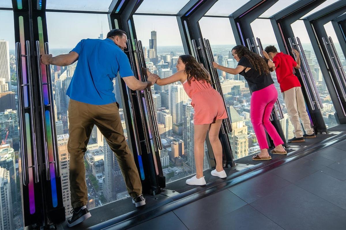 a group of people standing on the top of a building